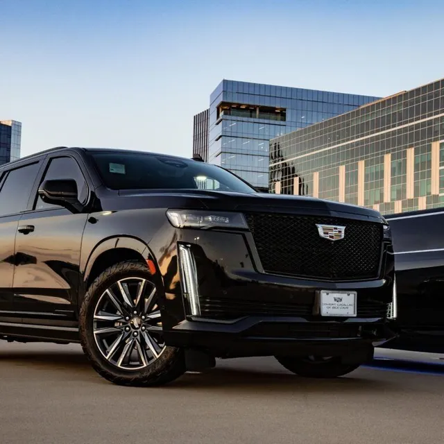Black luxury SUV providing SLC airport luxury transportation on a snowy mountain road in Utah.